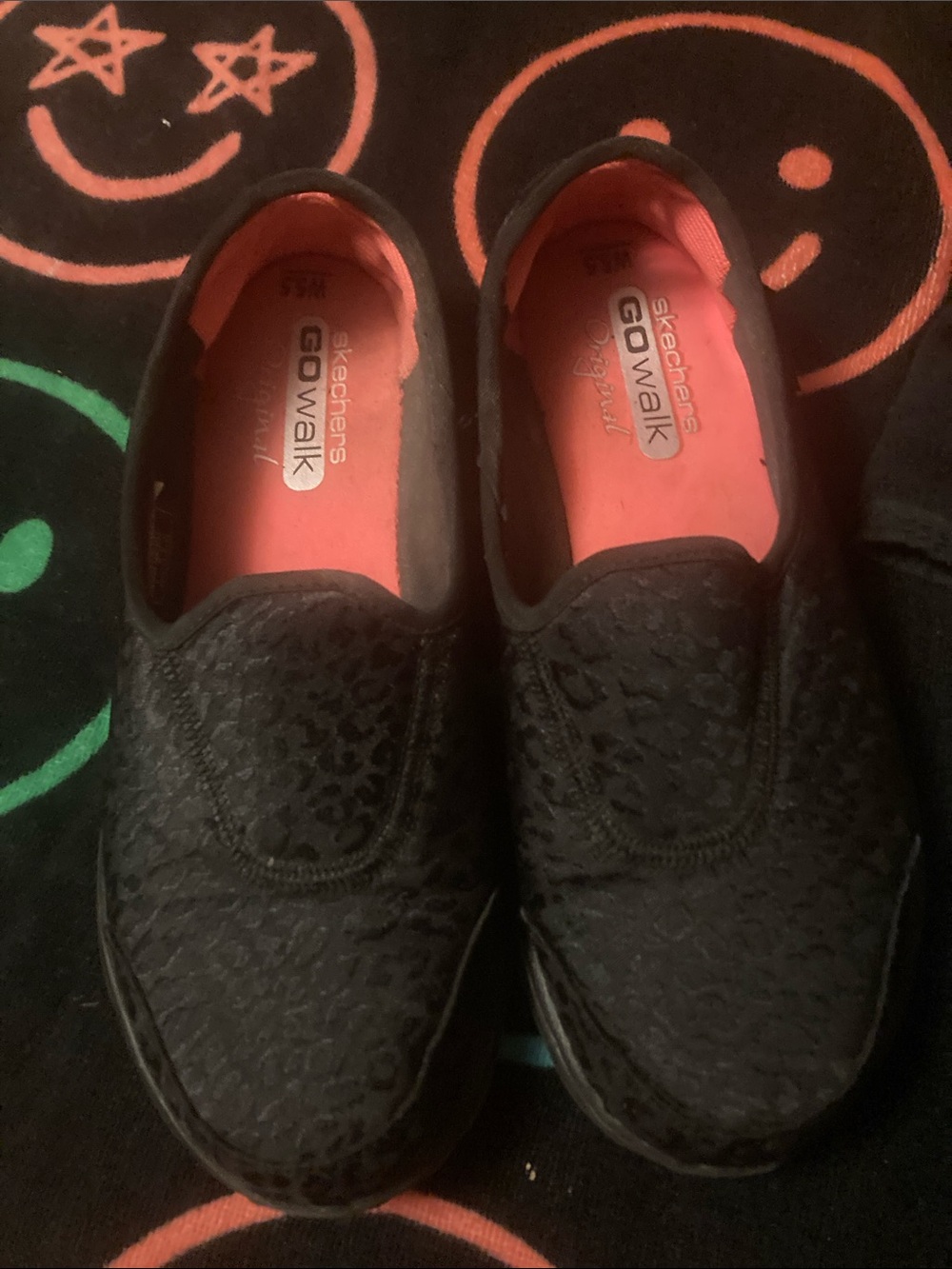 Skechers women’s black Slip-On Sneakers with Coral-Pink Insoles